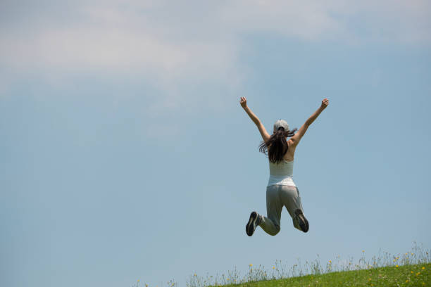 istock Women blue sky jump 936756500