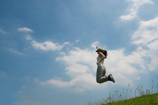 istock Women blue sky jump 936756796