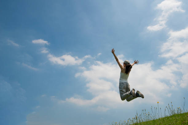 istock Women blue sky jump 936756798