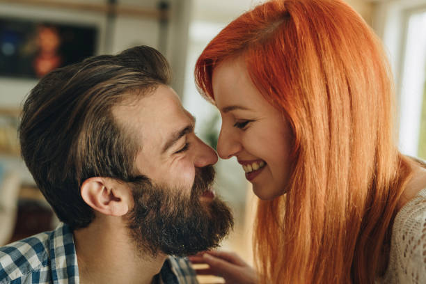 istock Affectionate couple touching with their noses at home. 936757152