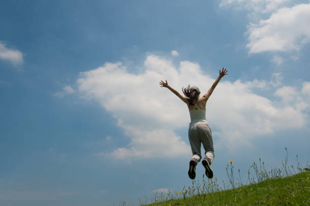 istock Women blue sky jump 936757192