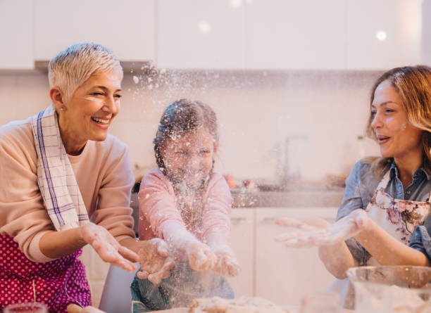 istock Playful extended family having fun with flour in the kitchen. 936760924