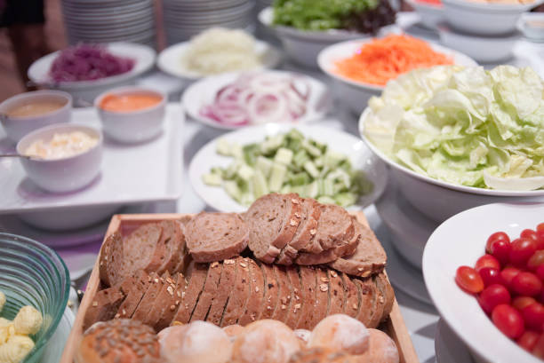 istock Salad buffet, Salad bar with bread various fresh vegetables and other foods. 936765126