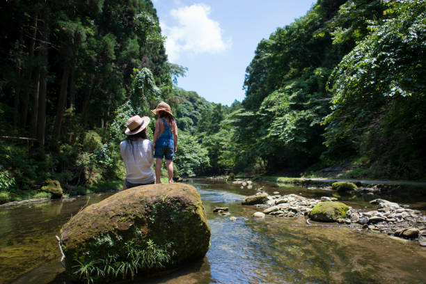 istock Mother and daughter playing in mountain stream 936765690