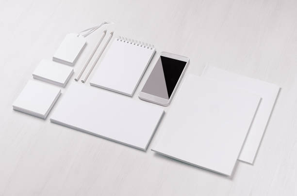 istock White blank stationery - label, notepad, letterhead, envelop, phone on soft white wooden plank, blank objects for placing your design, inclined. Modern stylish work place. 936766114