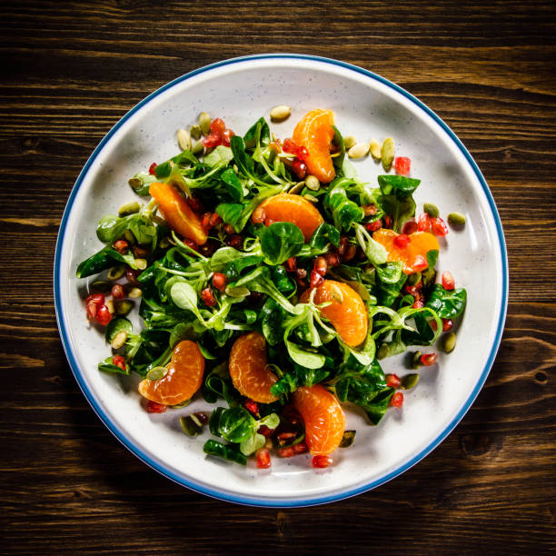 istock Vegetable salad on wooden background 936773256