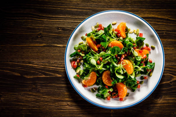 istock Vegetable salad on wooden background 936773264