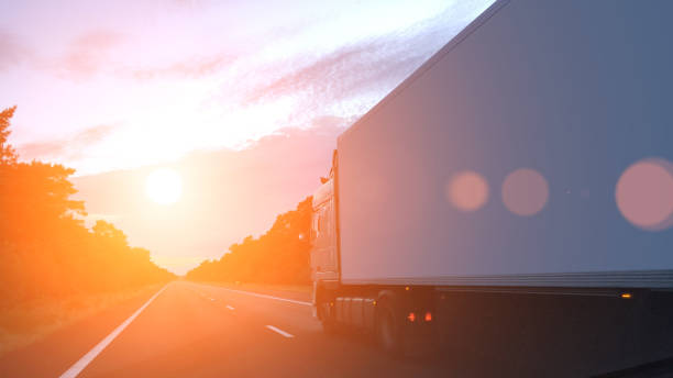 istock Cargo container truck highway road rural countryside sunset 936773988