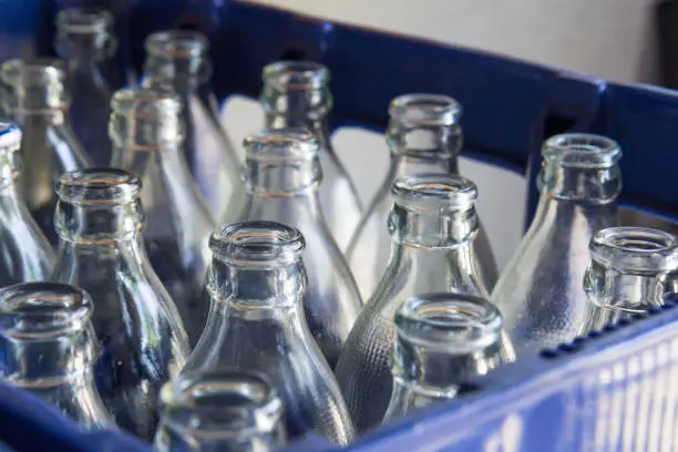 Photo of water glass bottles in blue plastic crate