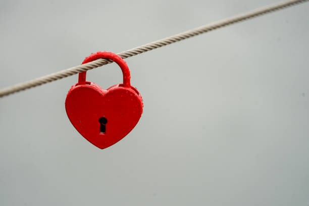 istock Colored locks hanging on the bridge for love 936781442