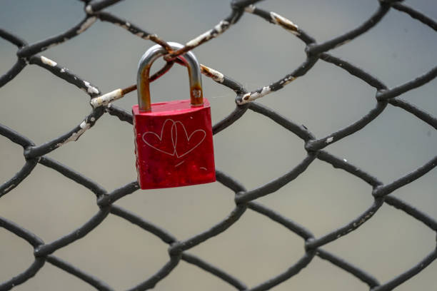 istock Colored locks hanging on the bridge for love 936781486