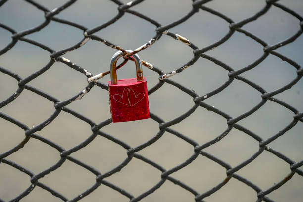 istock Colored locks hanging on the bridge for love 936781492