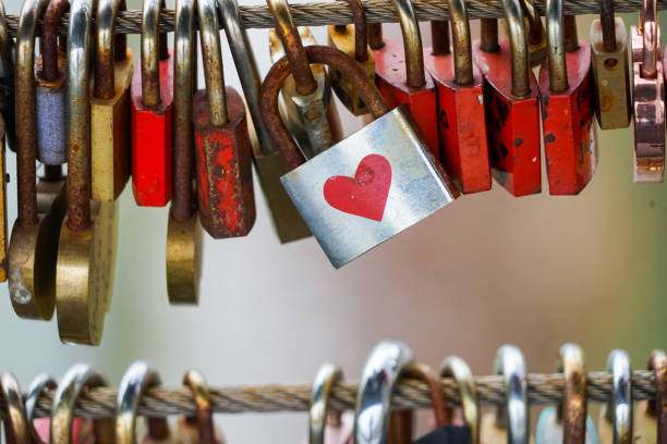 istock Colored locks hanging on the bridge for love 936781538