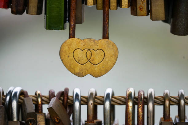istock Colored locks hanging on the bridge for love 936781596