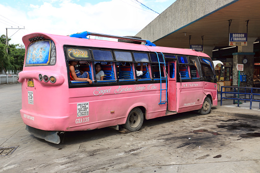 Cebu, Philippines - February 05, 2018: Old bus full of passengers is waiting to move from the bus station in Cebu City. The bus does not have a single window.