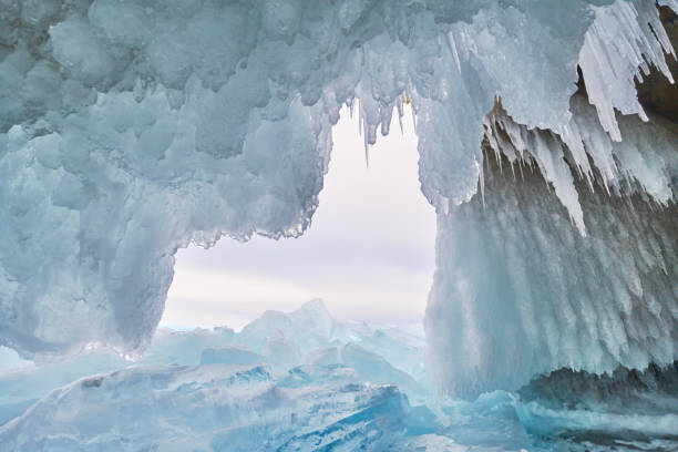 istock Lake Baikal is covered with ice and snow, strong cold, thick clear blue ice. Icicles hang from the rocks. Lake Baikal is a frosty winter day. Amazing place, heritage, Beauty of Russia 936794706