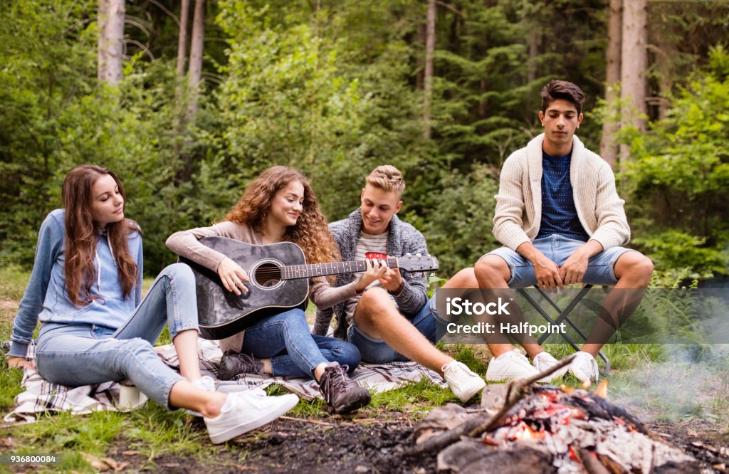 Teenagers Wit A Guitar Camping In Stock - Download Image Now - Camping, Teenager, - iStock