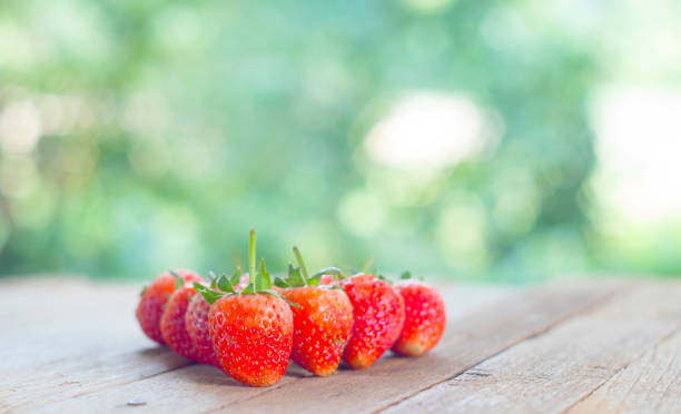istock background from freshly harvested strawberries on wood table, directly above 936805568