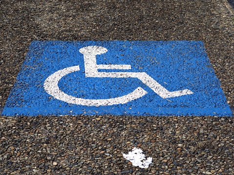 Disabled parking spot. Sign for parking for persons with disability or wheelchair bound persons. Close up.