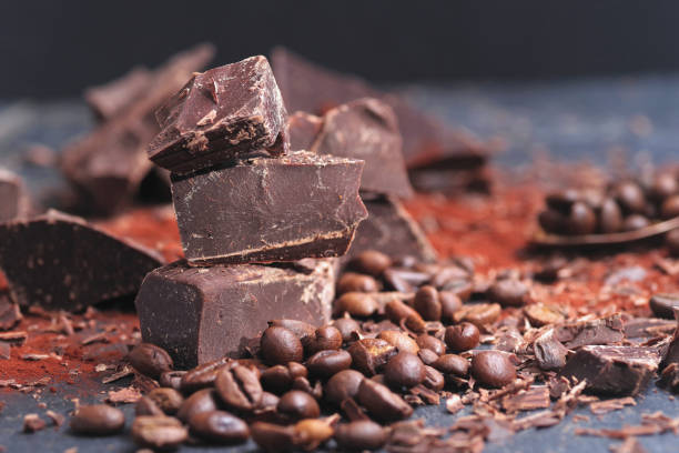 istock Broken dark chocolate, cocoa powder and coffee beans 936813254