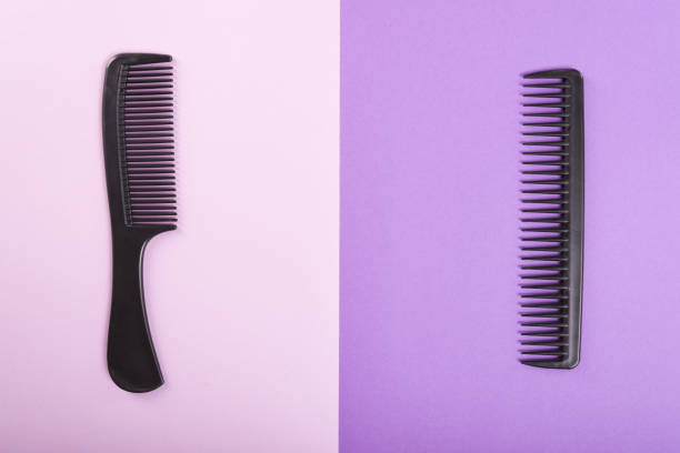 istock Two combs on pink and purple background 936816184