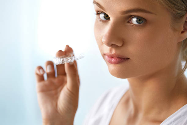 istock Beautiful Woman Holding Tray, Invisible Braces, Teeth Trainer 936816570