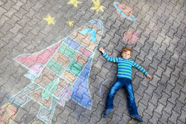 istock little kid boy flying by a space shuttle chalks picture 936816832