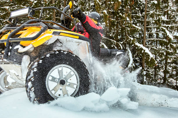 istock Winter race on an ATV on snow in the forest. 936817024