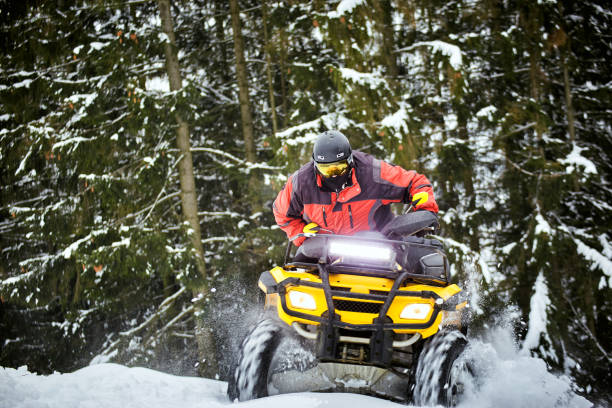 istock Winter race on an ATV on snow in the forest. 936817032