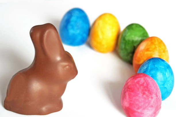 istock Easter greeting card with colored eggs and chocolate bunny 936818068