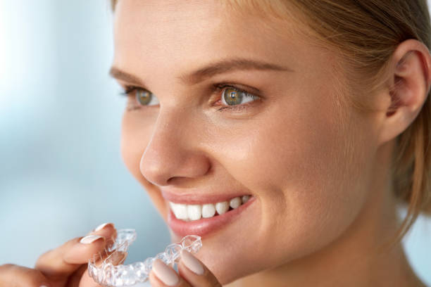 istock Smiling Woman With Beautiful Smile Using Invisible Teeth Trainer 936818496