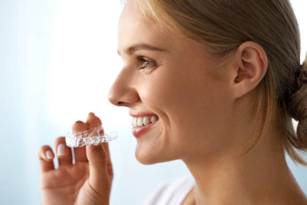 istock Smiling Woman With Beautiful Smile Using Invisible Teeth Trainer 936818748