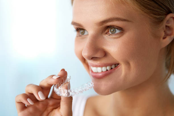 istock Smiling Woman With Beautiful Smile Using Invisible Teeth Trainer 936818840