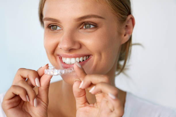 istock Smiling Woman With Beautiful Smile Using Teeth Whitening Tray 936821110