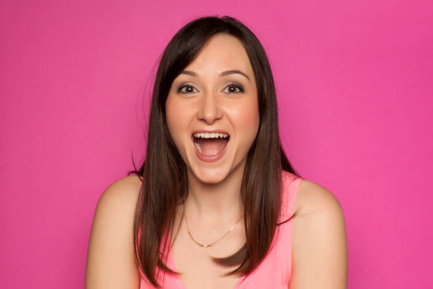 istock Young smiling woman on pink background 936821846