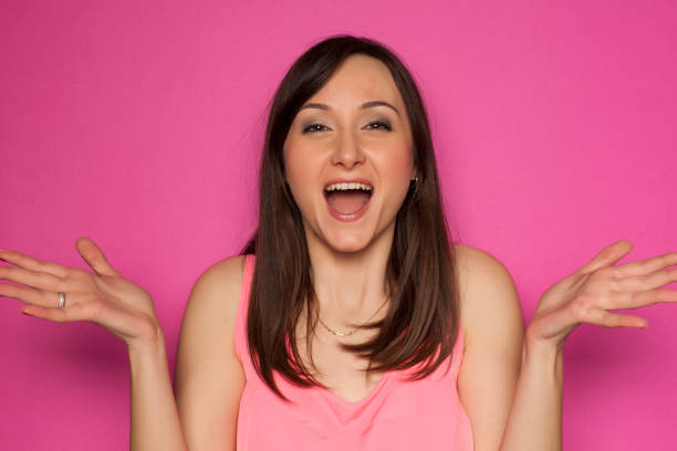 istock Young happy woman on pink background 936821886