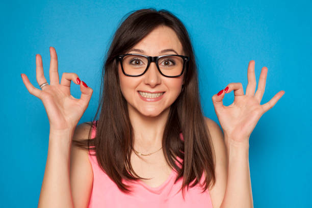 istock Young smiling woman with delicious gesture on blue background 936821946