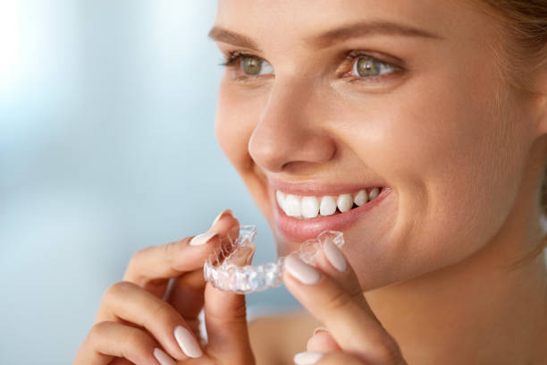 istock Smiling Woman With White Teeth Holding Teeth Whitening Tray 936822198