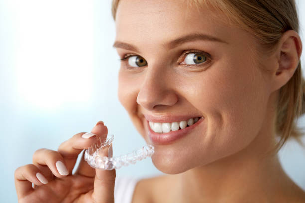 istock Smiling Woman With White Teeth Holding Teeth Whitening Tray 936825090
