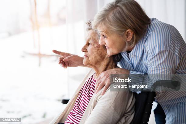 Senior Women With Wheelchair At Home Stock Photo - Download Image Now - Senior Adult, Healthcare Worker, Care