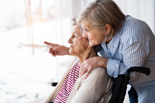 senior women with wheelchair at home. - senior adult winter senior women daughter imagens e fotografias de stock