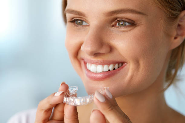 istock Smiling Woman With White Teeth Holding Teeth Whitening Tray 936825816