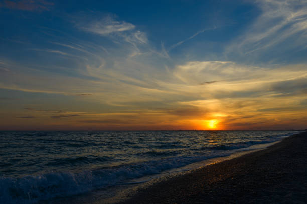 istock Beautiful sunset above the sea with waves 936826464