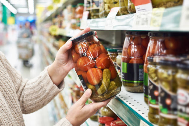 istock Hands  tomatoes and cucumbers in store 936826560