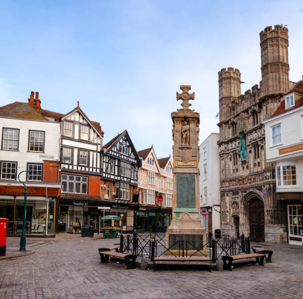 Canterbury Buttermarket in Old Town Kent Southern England UK CANTERBURY, UK - JUN 1, 2013: The War Memorial and Cathedral entrance at Buttermarket square in the morning. Canterbury is a historic English cathedral city and UNESCO World Heritage Site canterbury uk stock pictures, royalty-free photos & images
