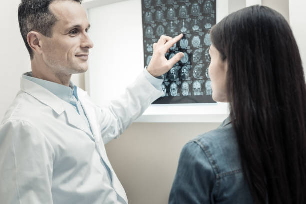 istock Cheerful positive doctor looking at his patient 936833146