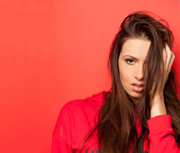 istock beautiful seductive woman in a red blouse on red background 936833706