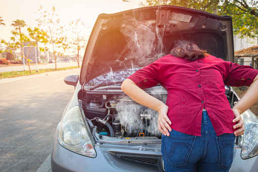 asian women worry and stress a trouble with car engine crash overheat