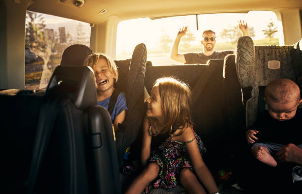 It's going to be fun fun fun! Shot of adorable little children sitting in a car road trip stock pictures, royalty-free photos & images