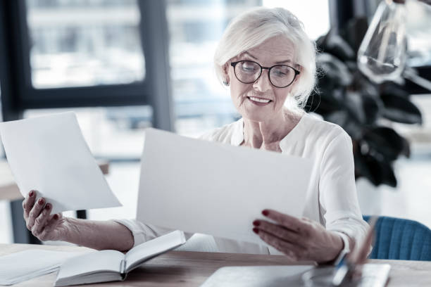 istock Positive delighted mature female working with pleasure 936837968